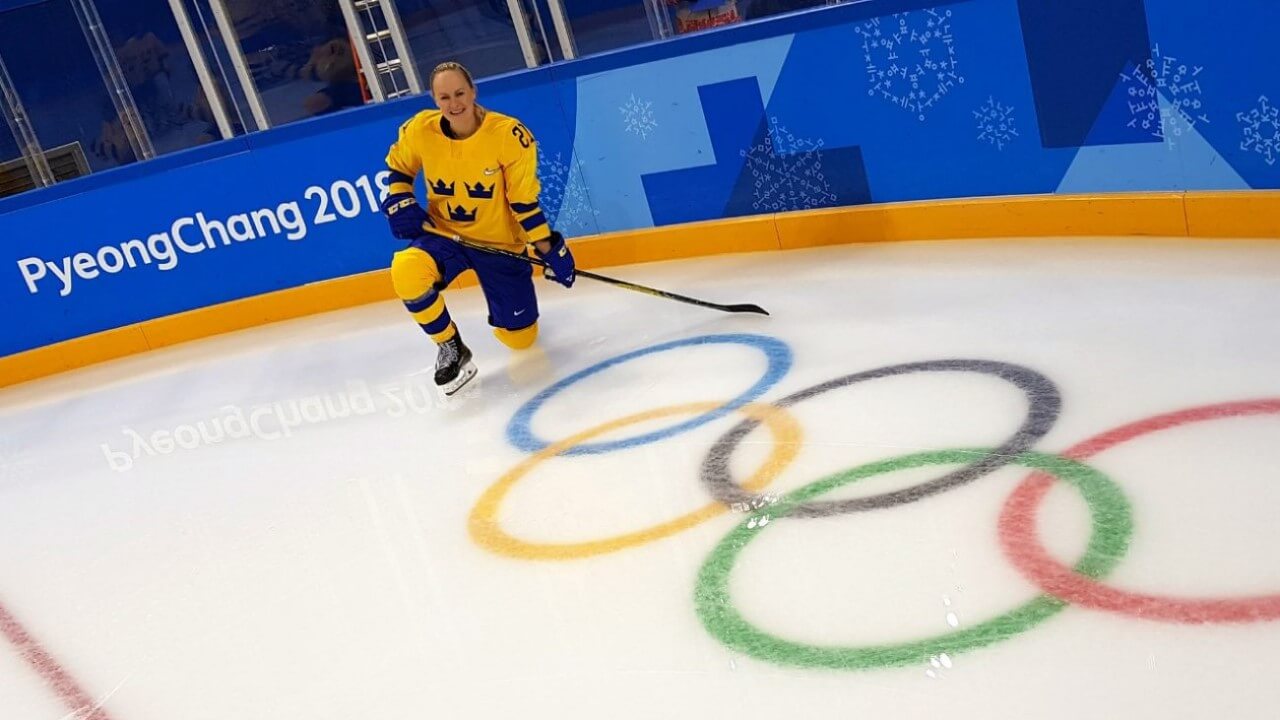 Udén Johansson kneels on the ice.