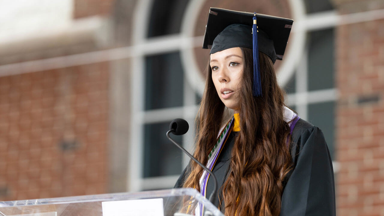 Haley Wong speaks from podium during commencement ceremony