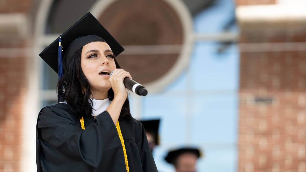 Rebekah Powers '21 sings the national anthem during Commencement
