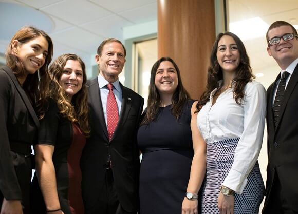 School of Law students take a photo with U.S. Senator during a visit to Quinnipiac School of Law.