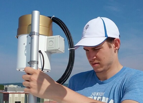 A civil engineering student works on a weather station on the York Hill Campus.