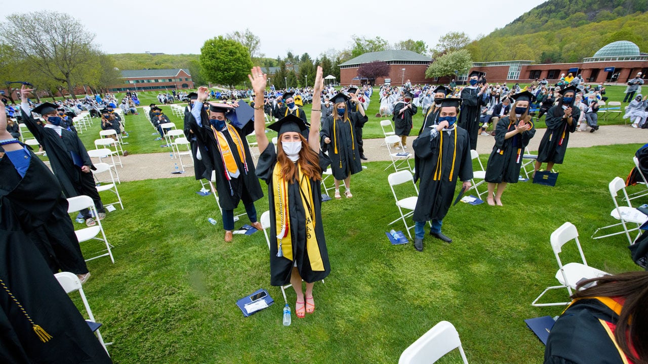 Graduates celebrate on the quad after receiving their degrees