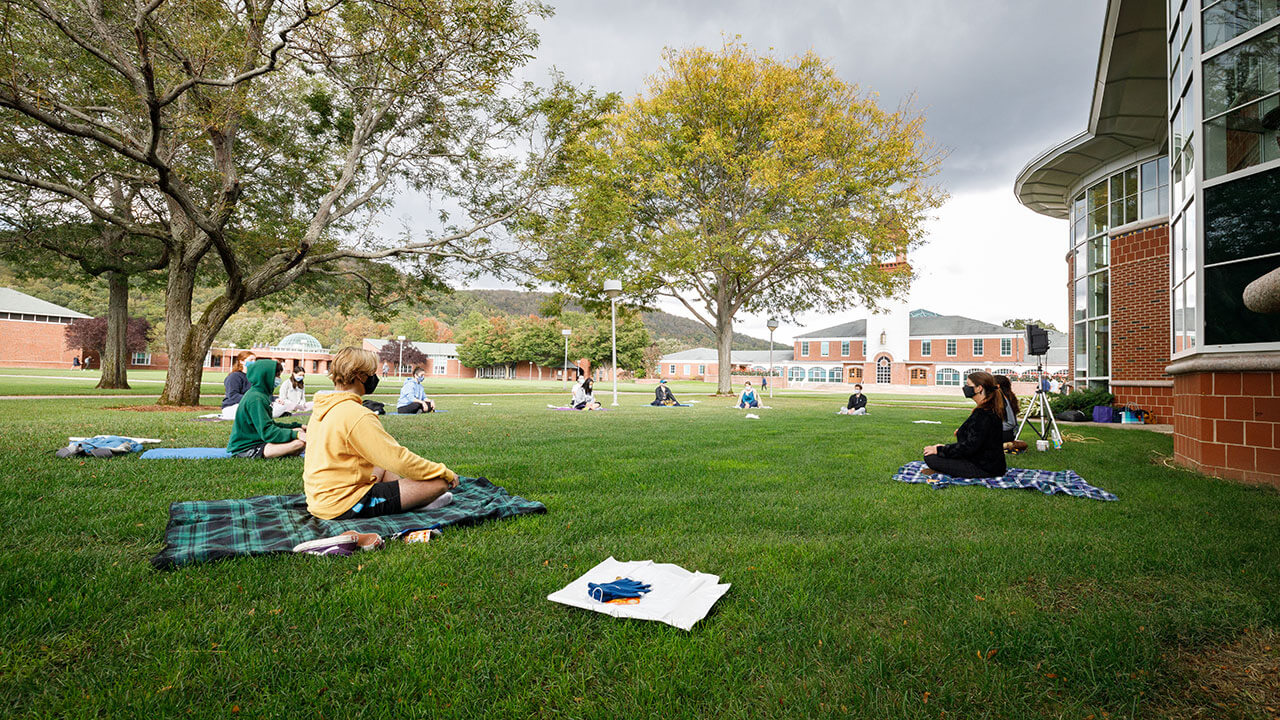 Students practice yoga and mindfulness on the quad