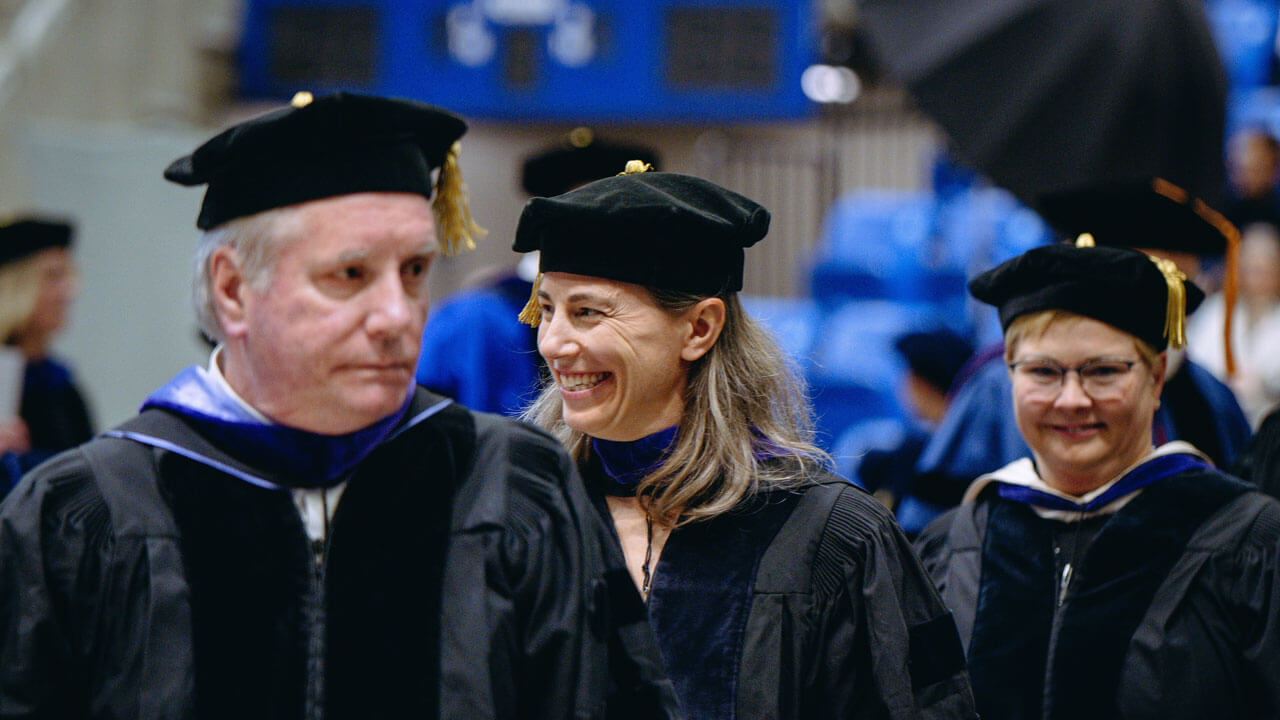 Faculty smiling at the School of Law 2024 Commencement