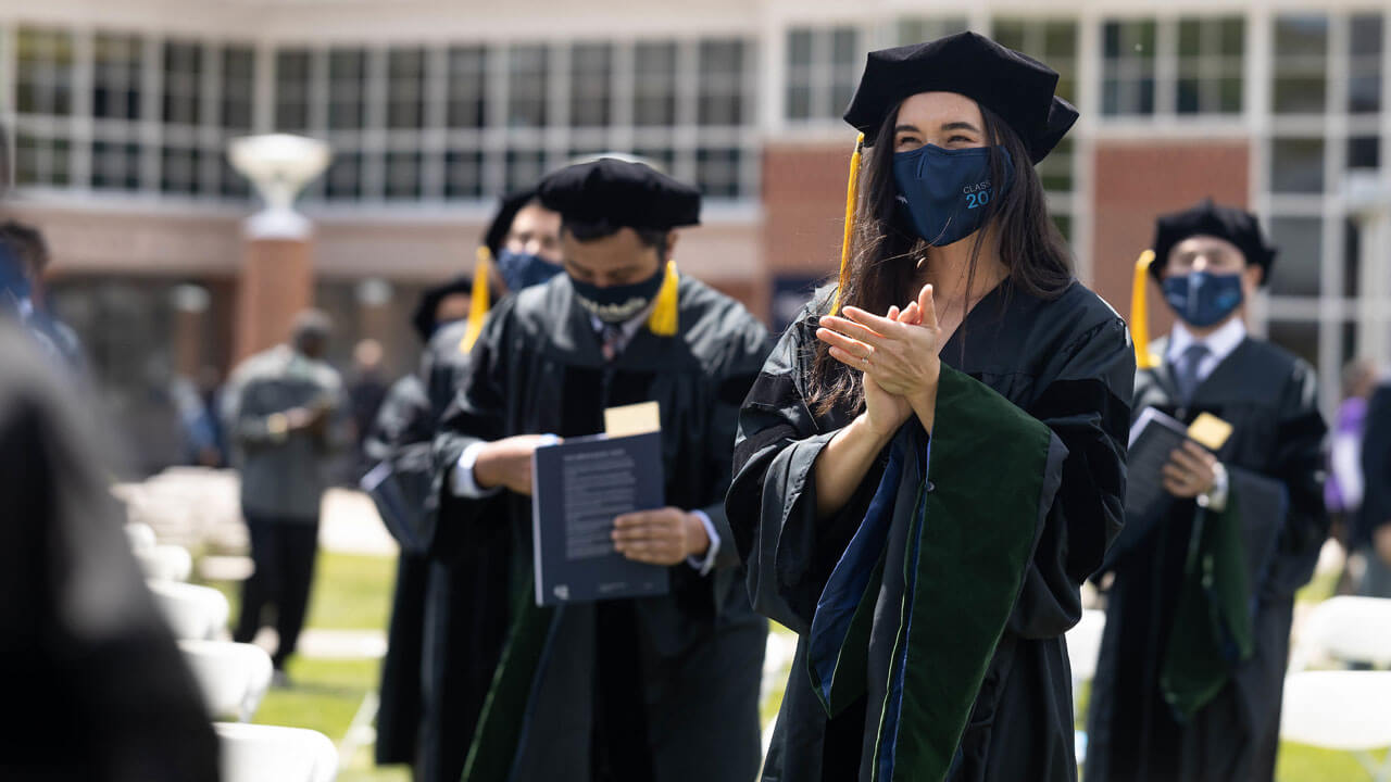 Medical school graduates clapping after commencment ceremony