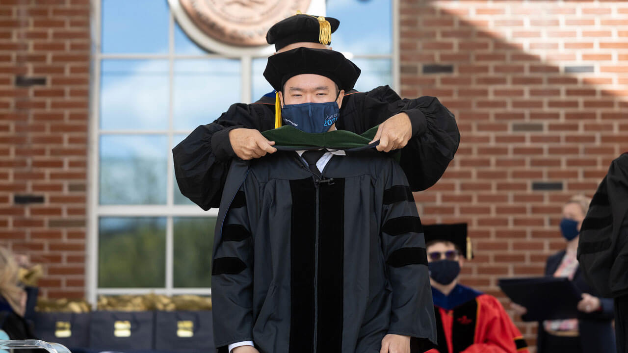 School of medicine graduate receiving his hood