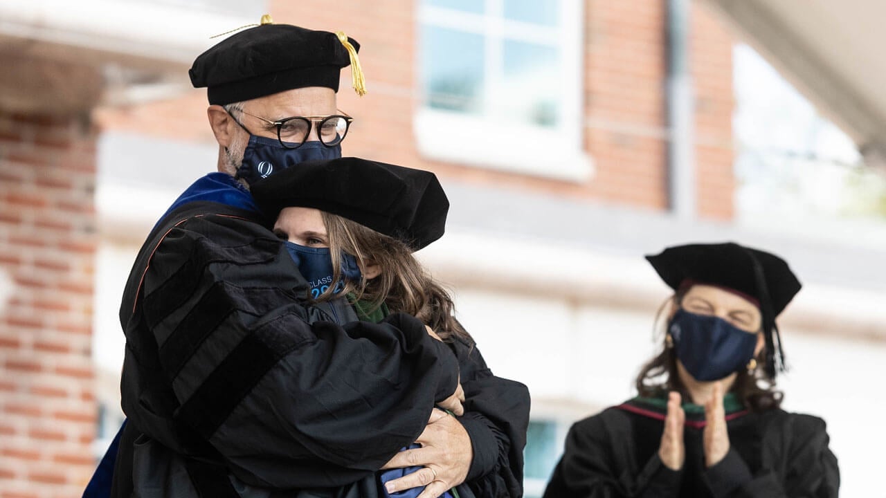 School of medicine graduate hugging at commencment