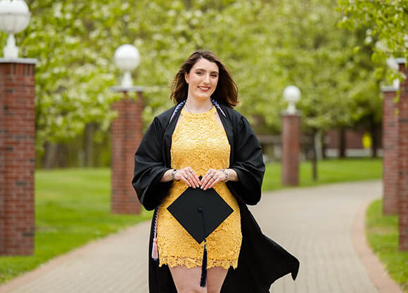 Mel Careri walking in her graduation gown and cap
