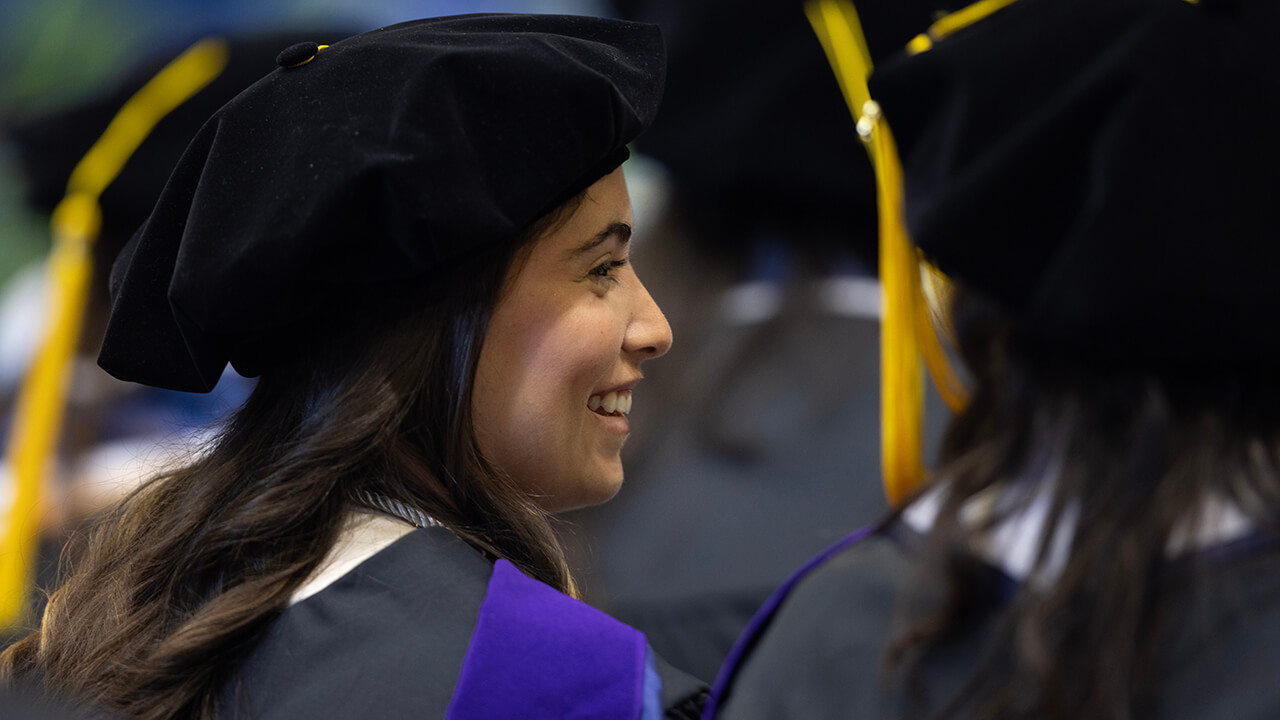 Graduate smiles in the crowd