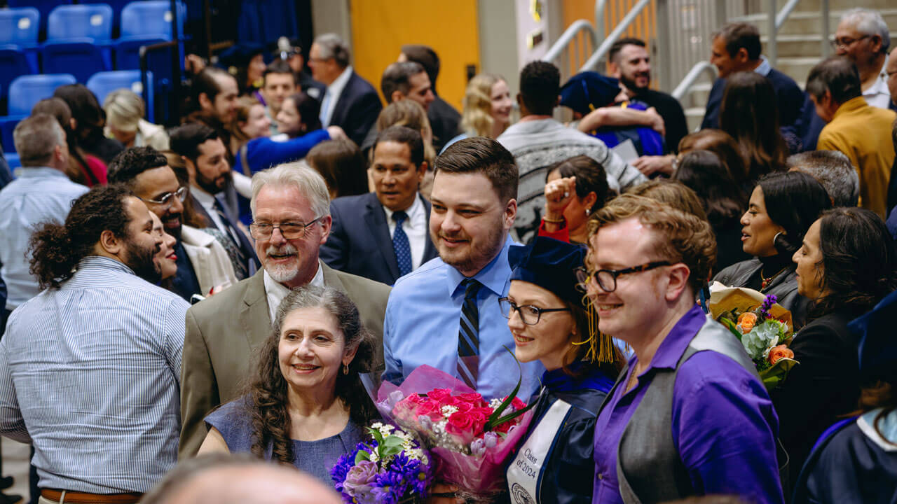 Family and friends gather to smile with a School of Law graduate student
