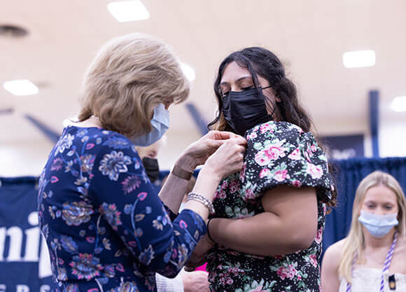 Student receives her pin a the School of Nursing Pinning Ceremony