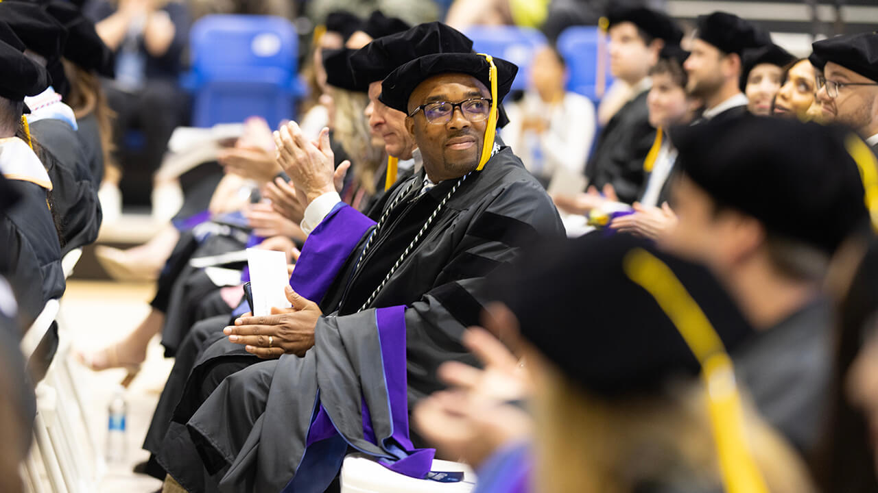Graduate turns around while seated to look at crowd