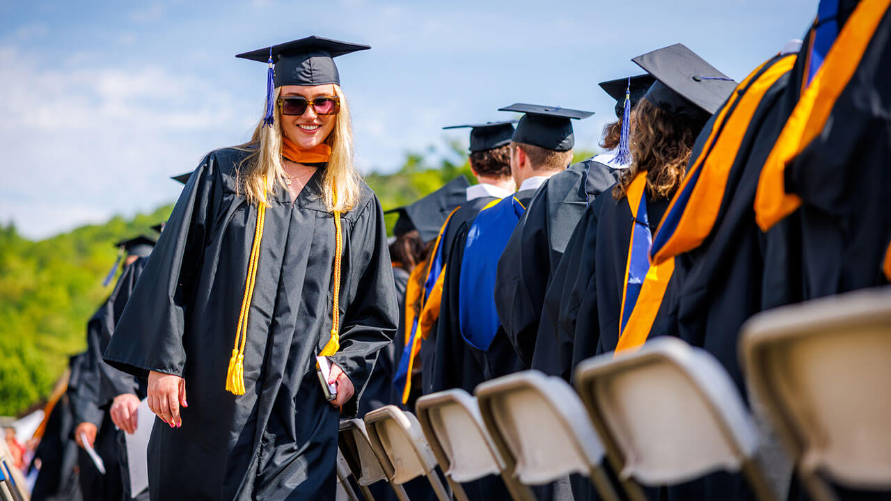 Graduate walks off stage with her sunglasses