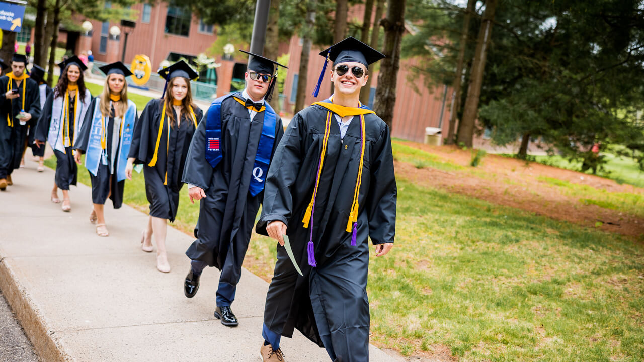 Graduates walk from the College of Arts and Sciences to the Quad during Processional