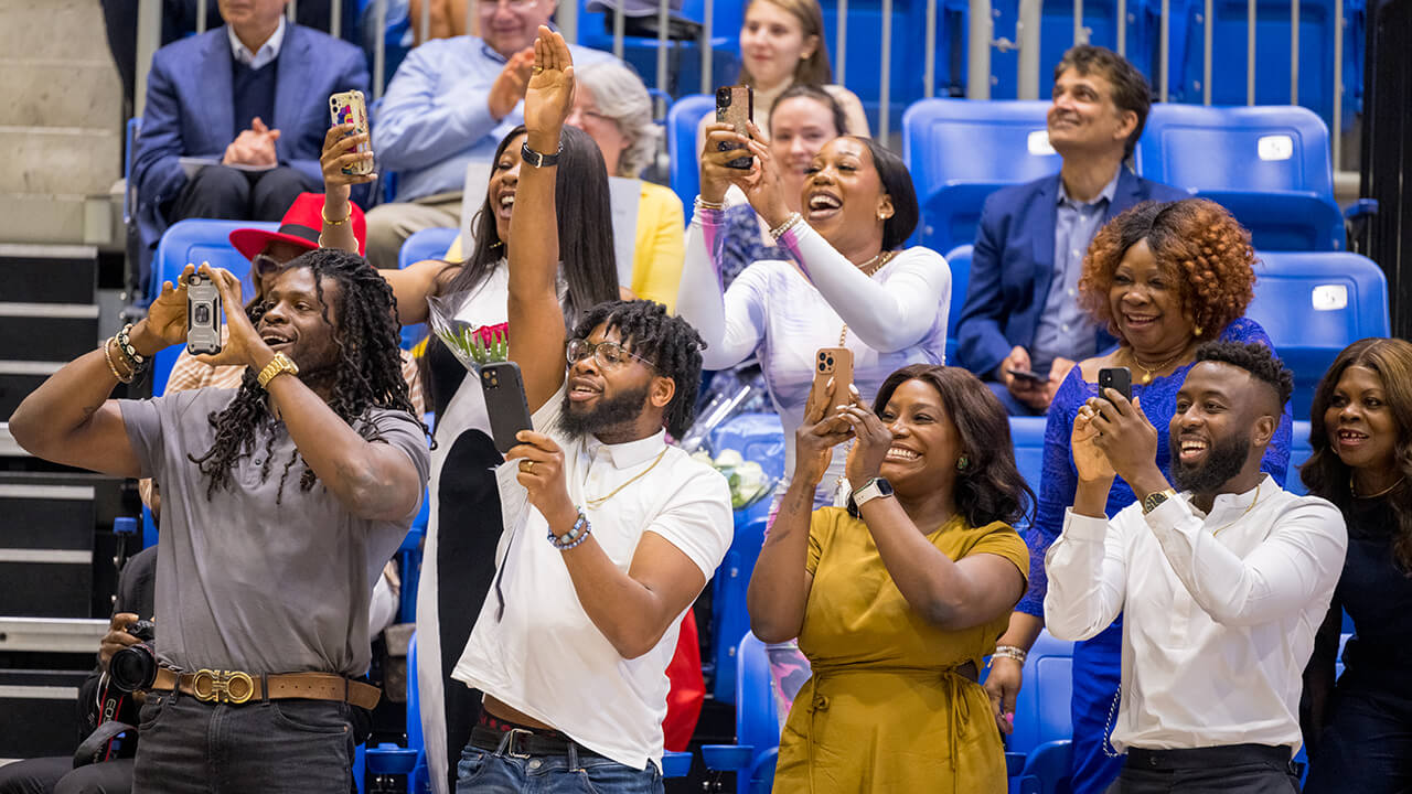Family and friends capture photos and cheer for graduates