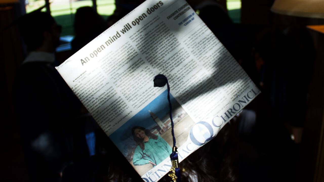 Graduate cap decorated with Quinnipiac Chronicle newspaper