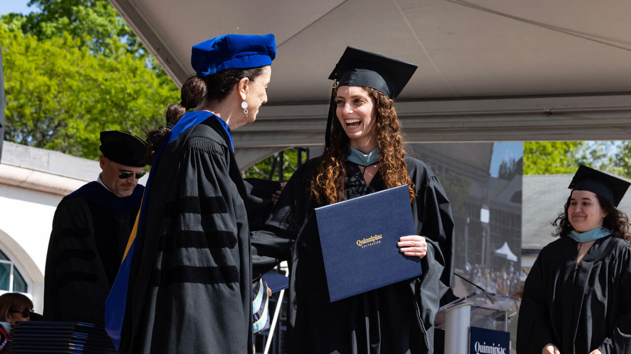 Graduate shakes hands with the dean