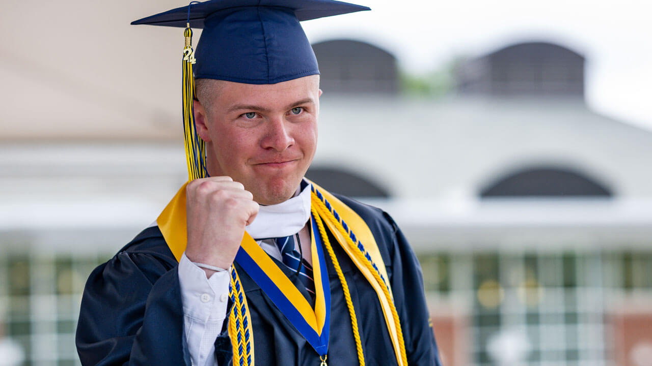 Graduate raises a proud hand after walking off stage