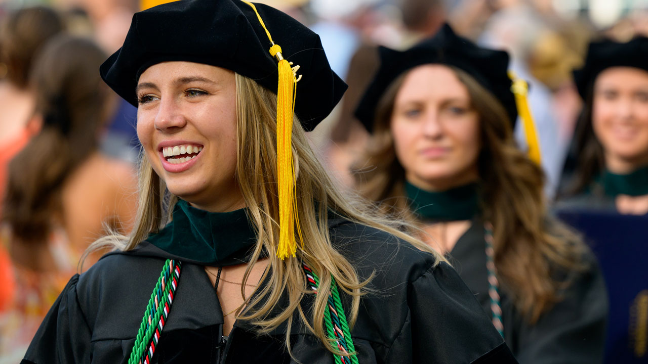 Zoomed in shot of graduate smiling and joyous during commencement