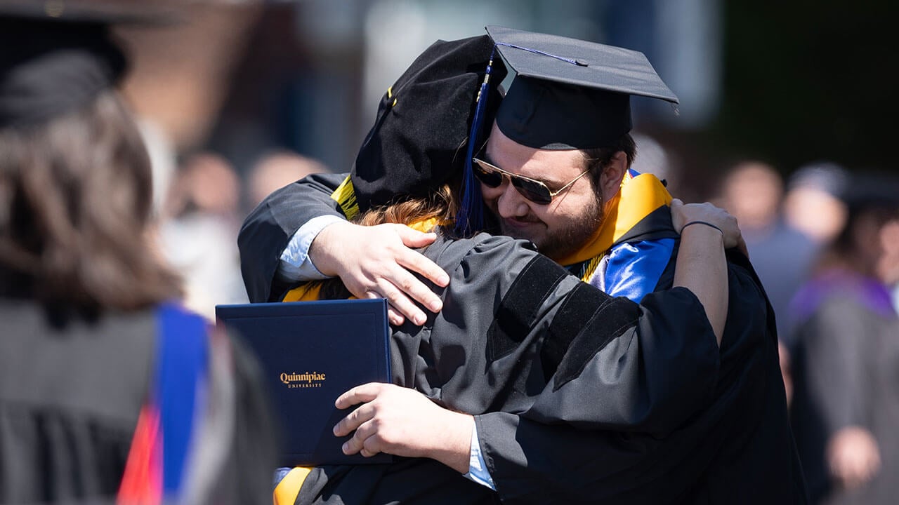 graduate hugs his professor