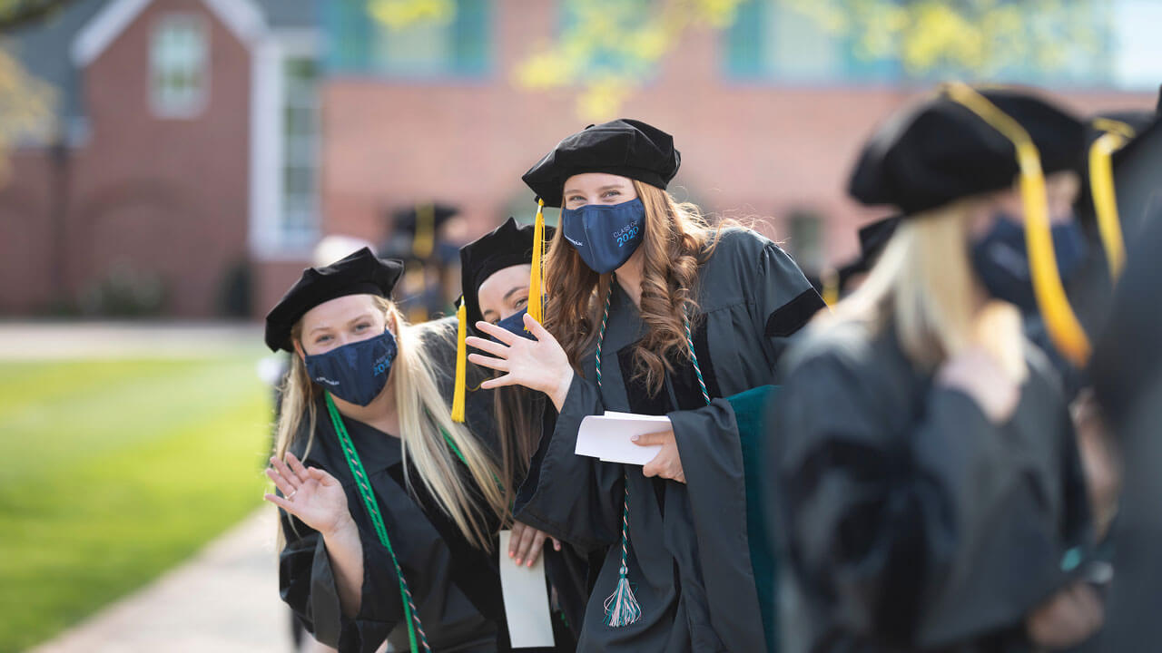 Graduates waving at camera
