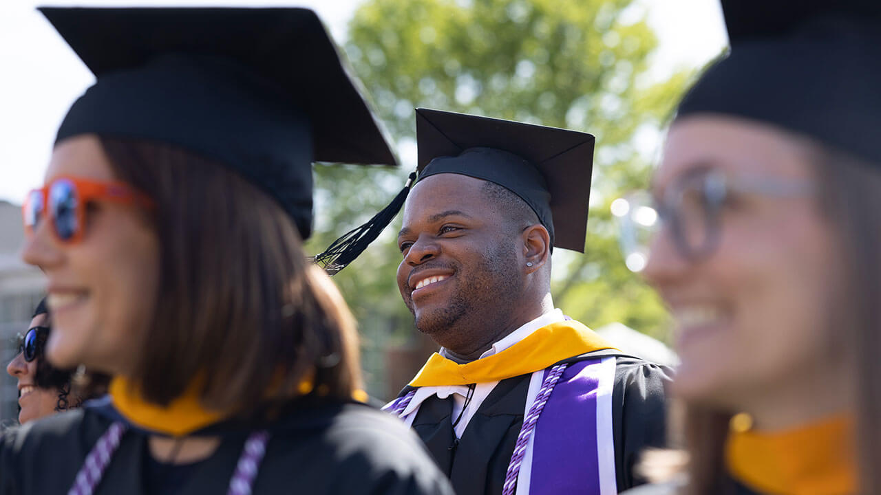 A graduate smiles as his tassel swings through the air