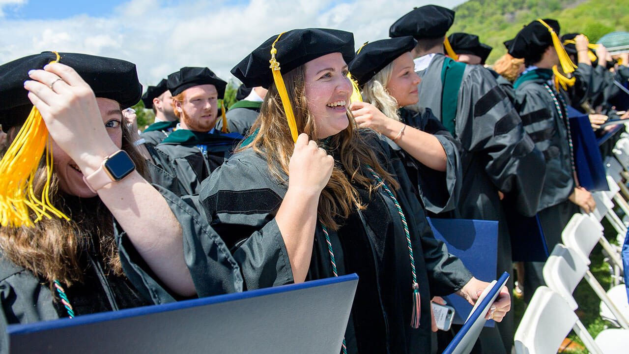 Graduate student grabs her tassel on her cap