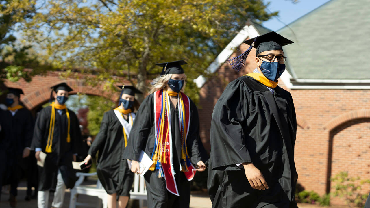 2020 graduates walking into commencement ceremony