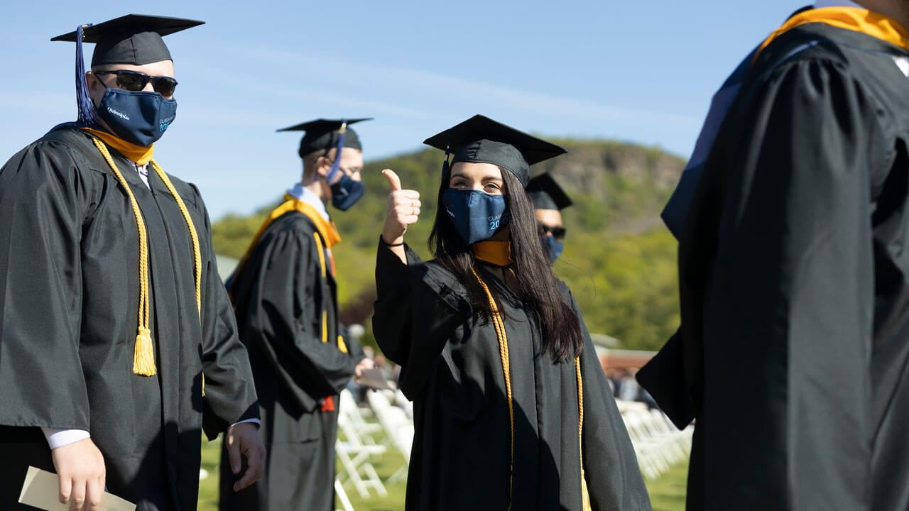 Graduate giving thumbs up to camera