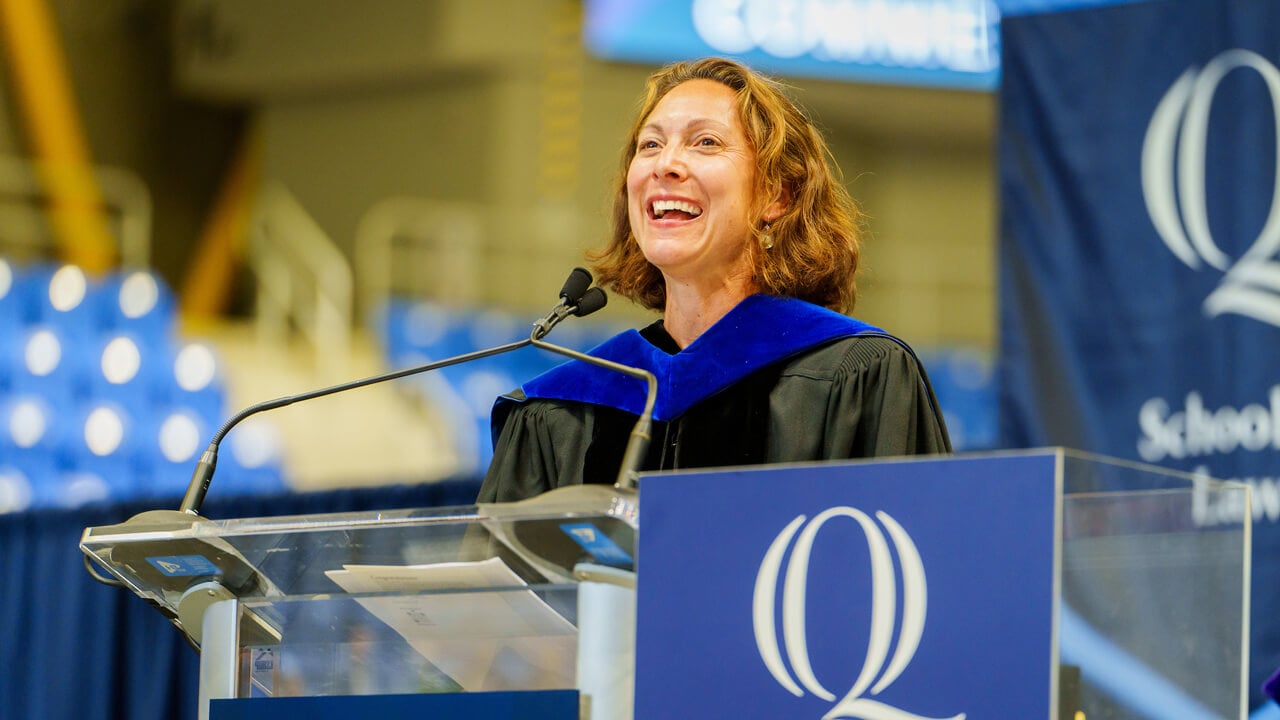 Emily Bazelon speaks from the Quinnipiac podium during her commencement keynote address