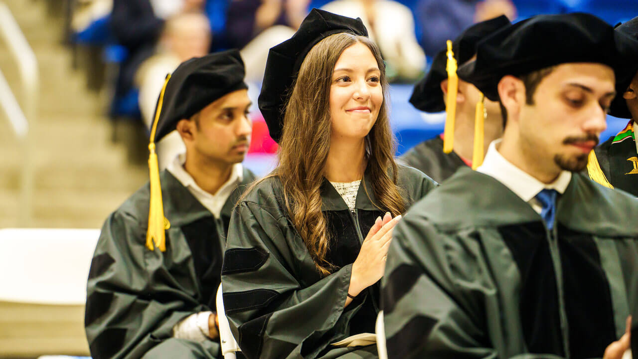 Medical graduate students applaud during commencement