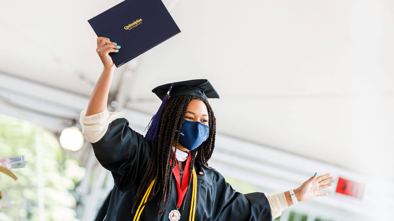 Graduate holding up her degree