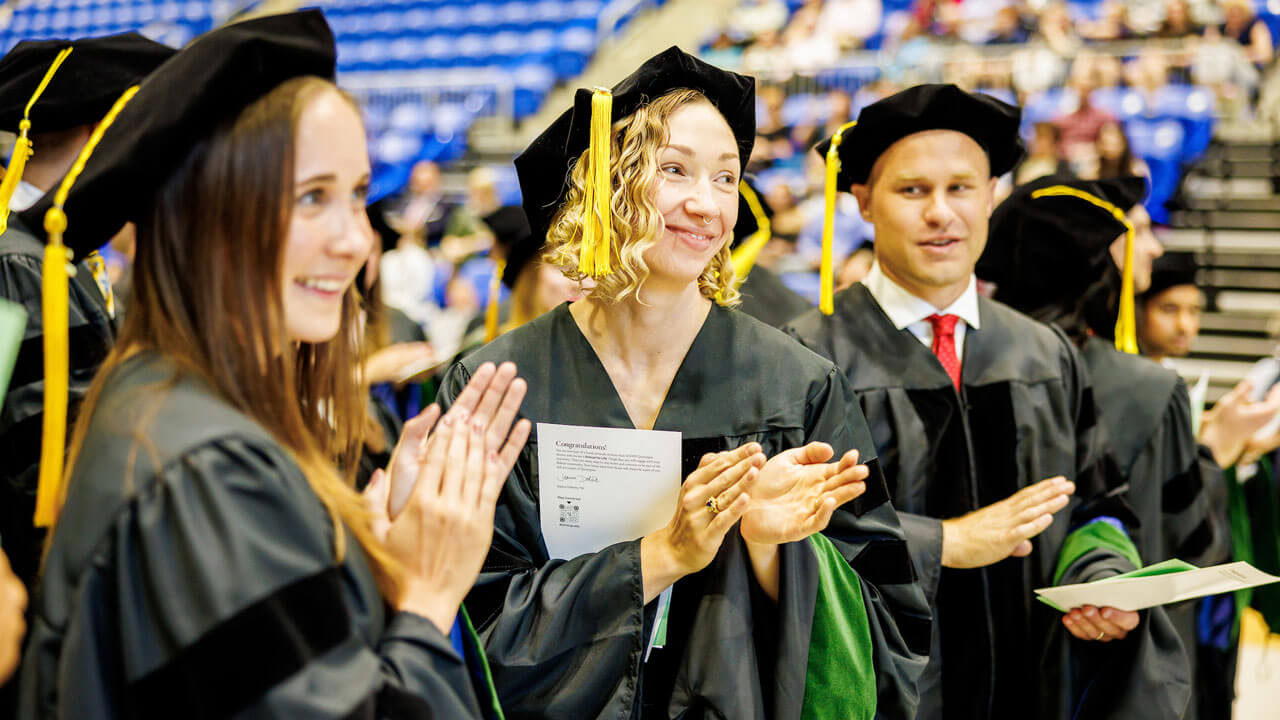 Medical graduate students applaud during commencement