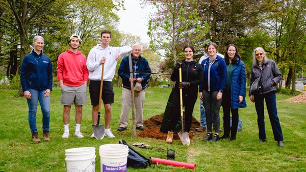 Students and faculty plant a tree on Arbor Day.