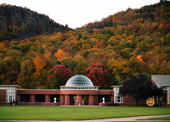 A colorful array of fall colors on the leaves on the Sleeping Giant State Park behind the business dome