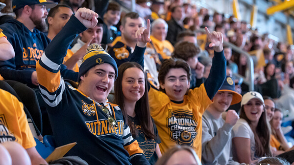 Hundreds of students wear Quinnipiac ice hockey national champions gear and cheer