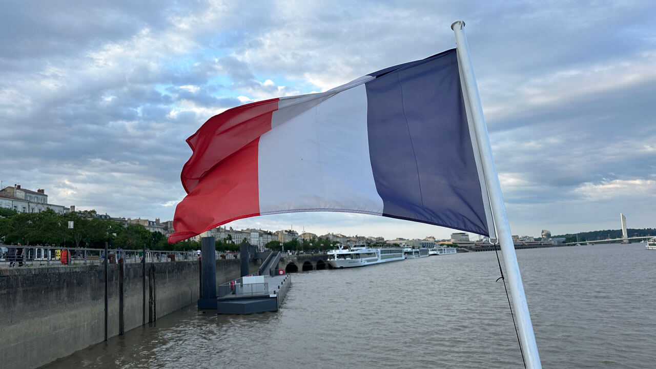 French flag waving on the edge of a boat