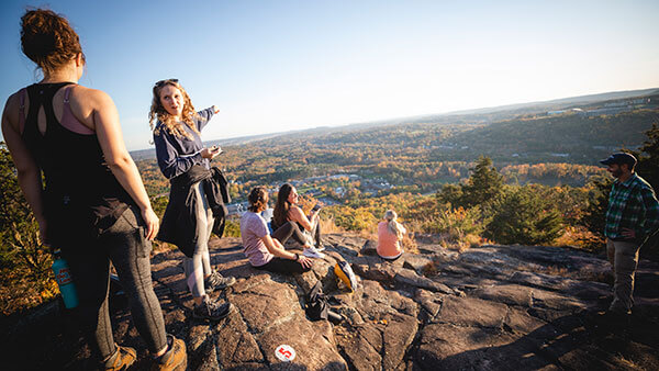 Students relax and take in the view at the top of Sleeping Giant State Park