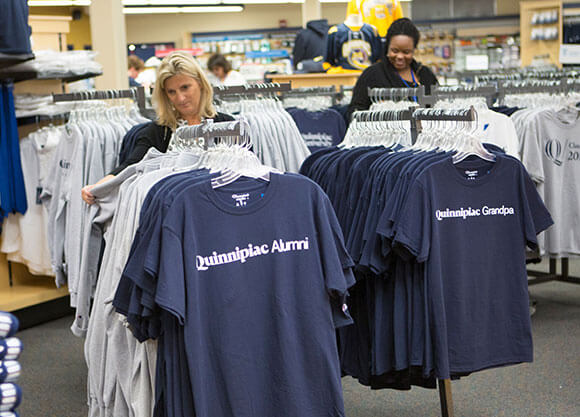 People shopping at the Quinnipiac bookstore for shirts