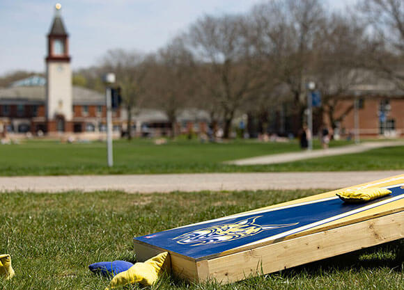A corn hole set sits on the Quad for students to enjoy