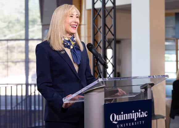 President Hardin speaks at a Quinnipiac University podium