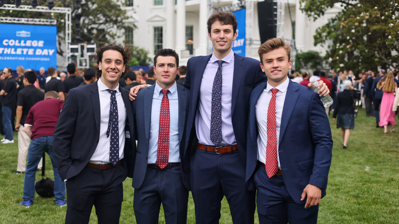 Hockey players smiling ear to ear in front of White House
