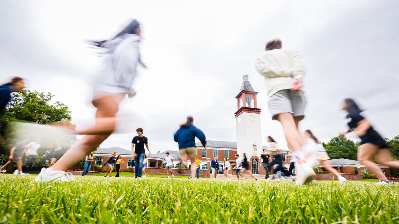 Students run on the quad during Orientation