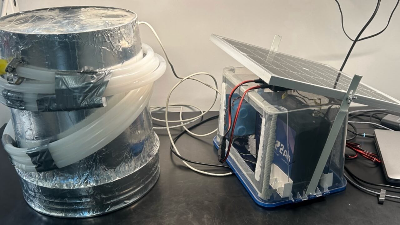 Photo of exterior of a complete V2 unit (flux chamber and separate electronic housing system with attached solar panels)