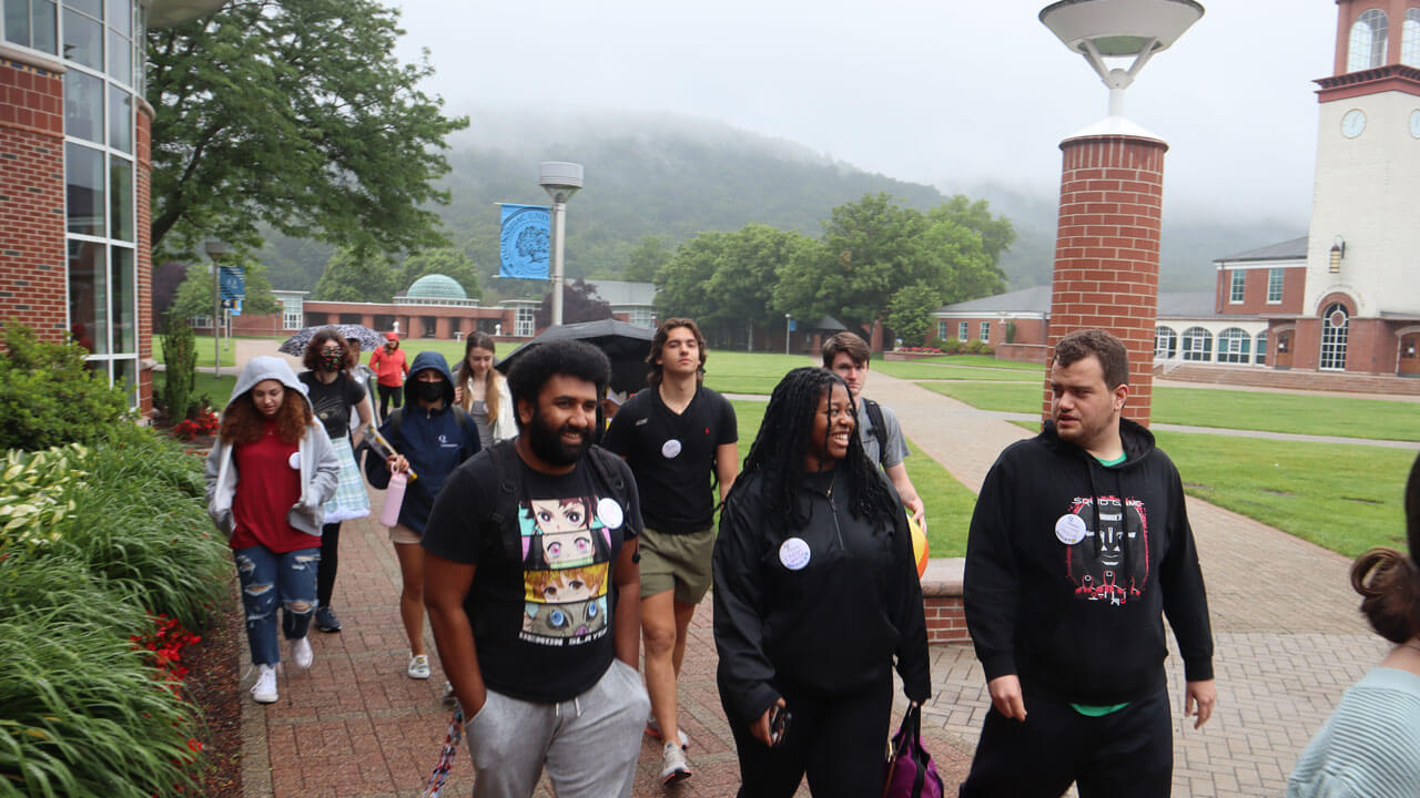 A group of new students walk across the quad during orientation