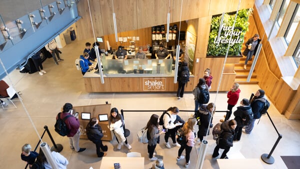 Dozens of students mill around the Shake Smart smoothie bar in Quinnipiac's RecWell
