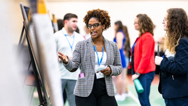 Student presenting their poster