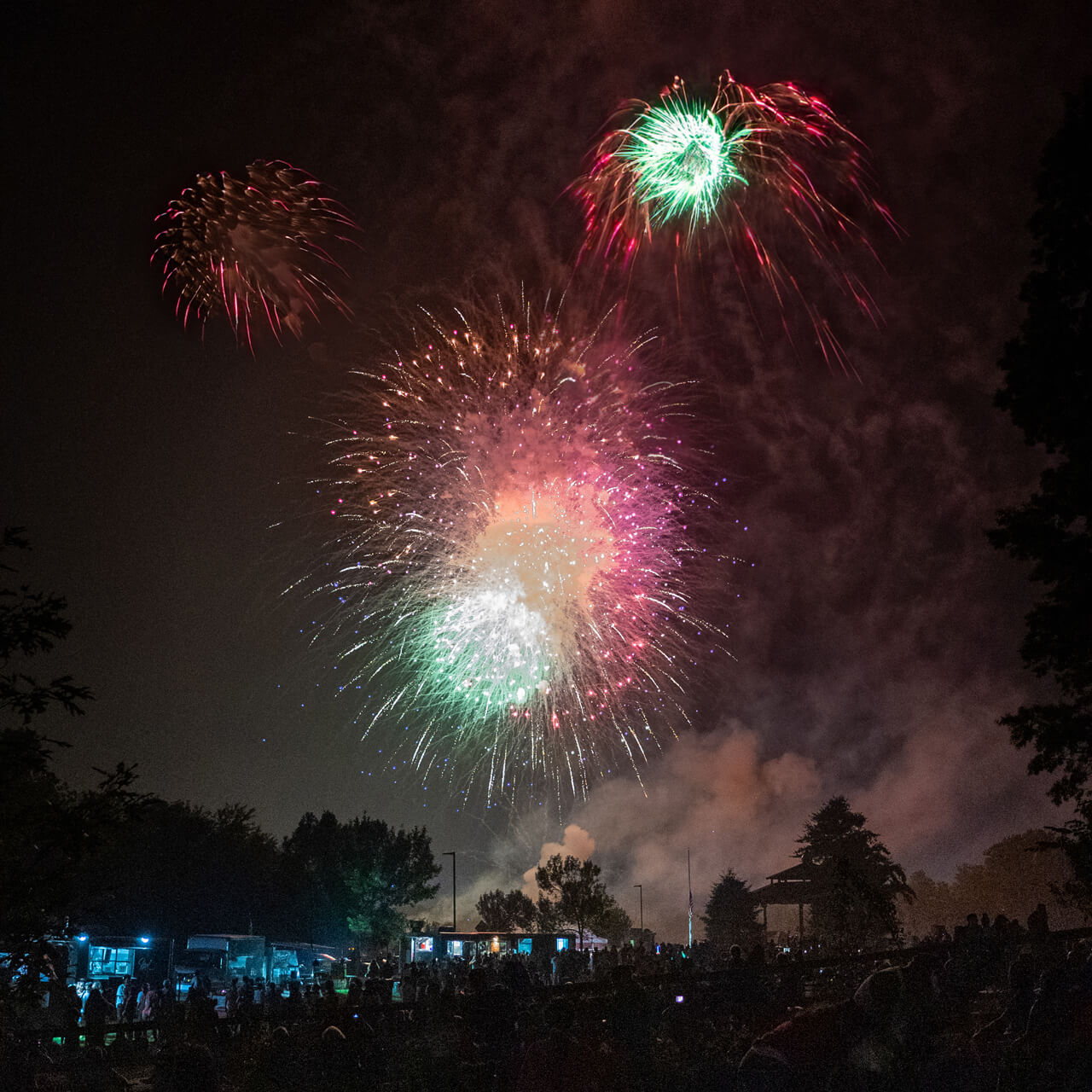Several colorful fireworks explode in the Hamden night sky
