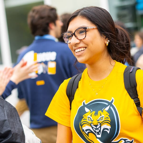 A student in a gold Bobcat shirt participates in an Orientation activity