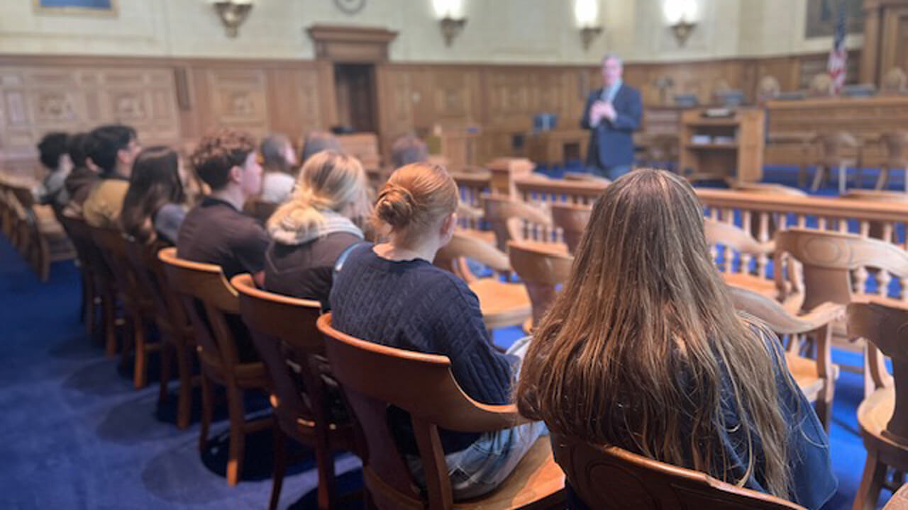 Students sit in a row in the courtroom listening to Justice Bright speak.